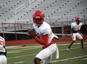 High school football camps are coming to a close and area teams are gearing up for the first game of their season. Penn Hills quarterback Hollis Mathis (wearing #12) during practice drills on Tuesday, August 15 at Yuhas-McGinley Stadium. Lillian DeDomenic | For The Tribune Review