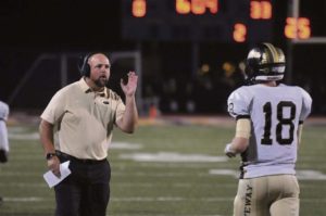Gateway coach Don Holl signals his quarterback Brady Walker during their game against Plum Friday, Oct. 6, 2017, at Plum.