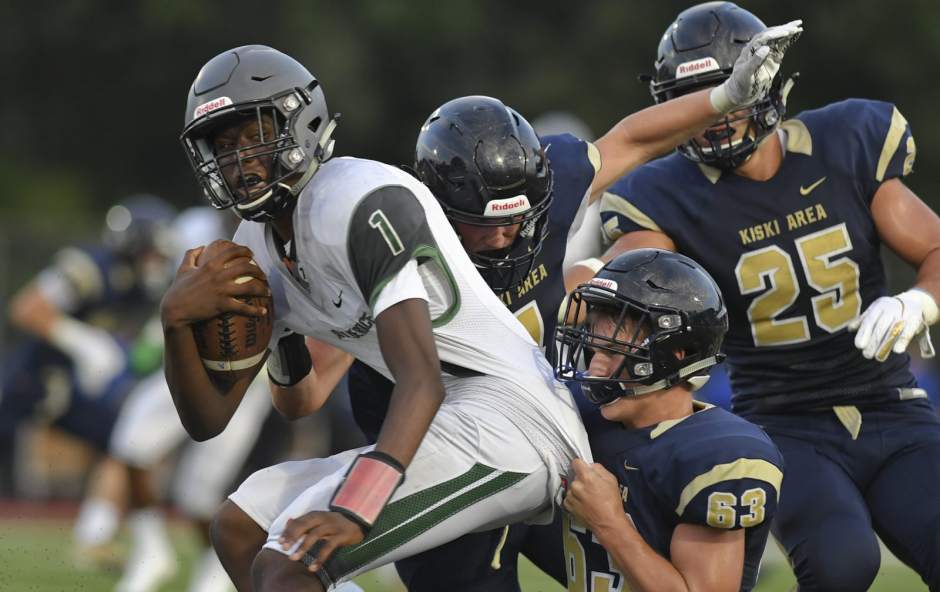 Allderdice Quarterback Dalen Dugger is pulled down by Kiski AreaÕs Hunter Dilts, Drew Dinunzio Biss and Jack Colecchi the Richard J. Dilts Stadium. Friday August 24, 2018.