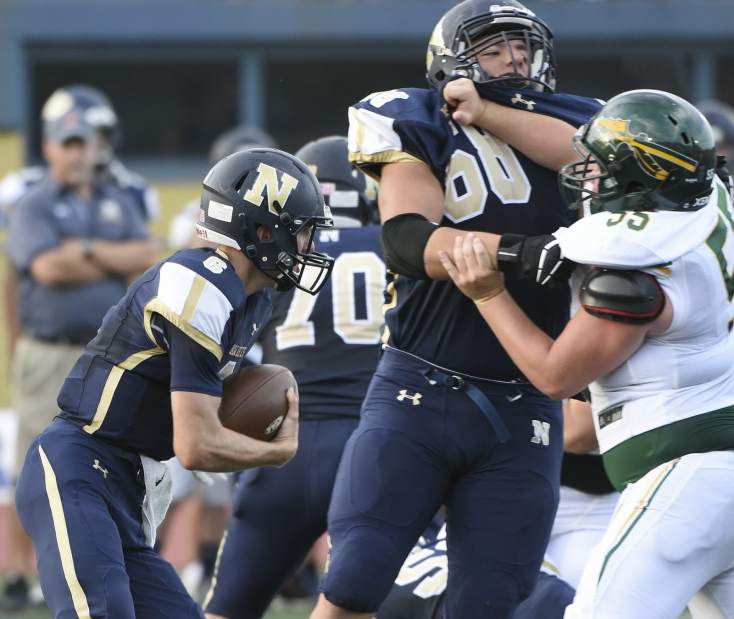Norwin quarterback Jack Salopek carries through the offensive line during the first quarter against Penn-Trafford Friday, Aug. 24, 2018, at Norwin Knights Stadium.