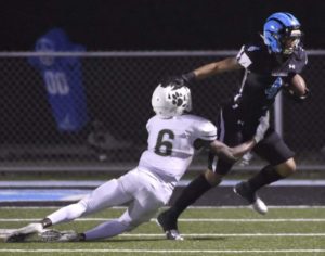 Woodrow Wilson's Jerus Belinga brings down Woodland Hills' Jayden Lucas during their game Saturday, Aug. 25, 2018, at the Wolvarena in Turtle Creek.