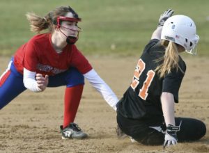 Springdales Brianna Thompson (21) steals second base next to St. Josephs Stella Swanson during their game Tuesday, April 2, 2019, at Kotecki Memorial Park.