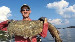Justin Johnson, perhaps the biggest name in kayak catfishing, holds a giant fish landed from his Hobie.