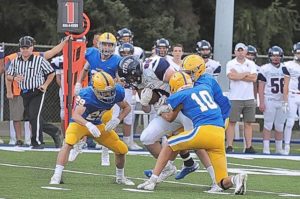 Shaler’s Logan Bernesser (80) makes a catch between three Hampton defenders September 6, 2019 at Hampton.