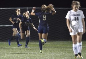 Kiski Areas Kaylee Elwood (21) celebrates her goal with Reagan Frederick (15) and Emerson Johngarlo next to Ringgolds Maddison Bailey during their WPIAL Class 3A first round playoff game Monday, Oct. 21, 2019, at Kiski Area High School.