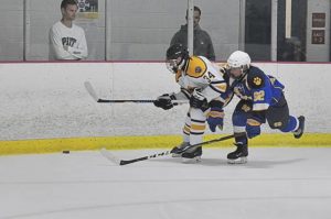 Franklin Regional’s Jake Rettger (34) and Hampton’s Ryan Koprivnikar (92) compete October 1, 2019 at Center Ice Arena.