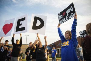 Lucy Knepp, 10, of Hempfield, waves a sign alongside friends and family of Eddie Coletta on Wednesday<ins>,</ins><ins> Sept. 23, 2020</ins> during a supportive rally at Hempfield Area High School.