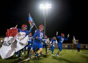 Jeannettes football team breaks through a banner before their game against Avella on Friday, Oct. 30, 2020.