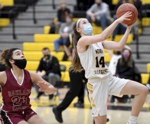 North Allegheny’s Cam Phillips drives past Oakland Catholic’s Halena Hill during their game on Saturday, Feb. 6, 2021, at North Allegheny High School.