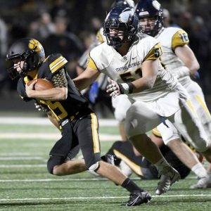 Central Catholic’s Donovan Hinish pressures North Allegheny quarterback Tanner Potts during the second quarter on Friday, Sept. 24, 2021, at North Allegheny High School.