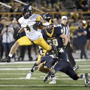 Central Catholic’s Gannon Carothers hurdles Mt. Lebanon’s Tommy Boehner during their game on Friday, Oct. 8, 2021, at Mt. Lebanon High School.