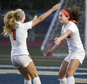 Latrobes Ella Bulava (right) celebrates her goal with Regan Reilly on Sept. 30, 2021, at Norwin. Latrobe clinched its first section title since 1992 with a 3-0 win over Hempfield on Tuesday.