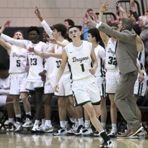 The Allderdice bench celebrates a 3-pointer by Logan Golle during a PIAA Class 6A playoff game against Central Catholic last season.