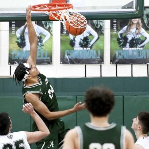 Allderdices Major Rainey dunks over Pine-Richland defenders during their game on Wednesday at Pine-Richland.