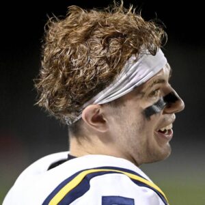 Central Catholic quarterback Payton Wehner smiles on the sideline after throwing his fourth touchdown pass against Woodland Hills on Friday, Aug. 25, 2023, at the Wolvarena.