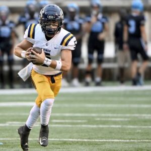 Central Catholic quarterback Payton Wehner carries against Woodland Hills on Friday, Aug. 25, 2023, at the Wolvarena.