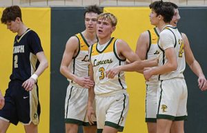 Deer Lakes’ Collin Rodgers (3), Derek Lang (24) and Nathaniel Moore react to an and-one call against Knoch on Jan. 7.