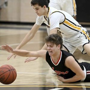 Avonworth’s Billy Onyshko battles Quaker Valley’s Sam Chapman for a loose ball Jan. 3 in Leetsdale.