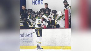 Penn-Trafford’s Brock Bienemann (57) celebrates his first goal with teammates during their game against Latrobe on Feb. 10.