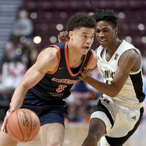 Neighborhood Academy’s Courtney Wallace drives to the basket past Sankofa Freedom’s Jameel Brown during the PIAA Class A state championship game on Thursday, March 27, 2025, at Giant Center in Hershey.