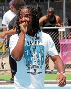 Woodland Hills football player Scoop Smith enjoys some of the action during his camp Sunday.