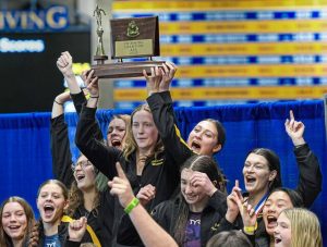 The North Allegheny girls swim team hoists the championship trophy at the WPIAL Class 3A meet Feb. 28 at Pitt’s Trees Pool.