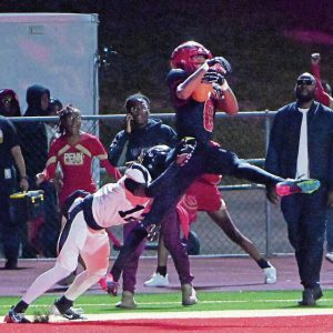 Penn Hills’ Carter Bonner catches a touchdown pass over Alquippa’s Larry Moon on Friday, Sept. 20, 2024, at Penn Hills High School.