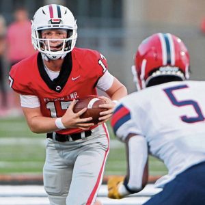 Peters Township quarterback Nolan DiLucia carries against McKeesport’s Anthony Boyd on Aug. 30, 2024.
