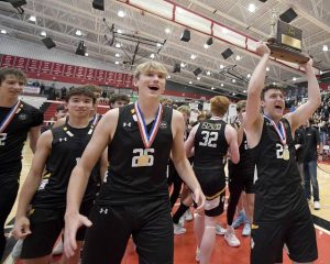 The North Allegheny boys volleyball team celebrates with the WPIAL championship trophy after defeating Seneca Valley in the Class 3A final on May 24.