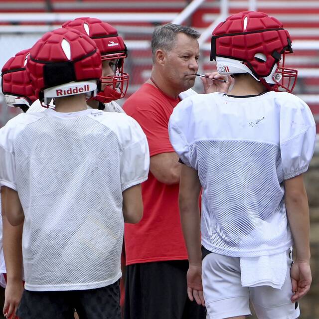 North Hills head coach Pat Carey works with his team during practice Aug. 6 at Martorelli Stadium.