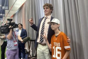 Texas quarterback Arch Manning meets super-fan Connor Petrozlello, 13, at SEC media days Tuesday.