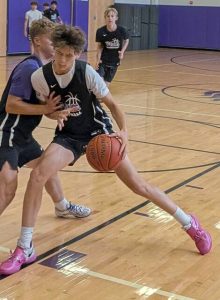 Sophomore guard/forward Xavier Barto works with the ball while being closely guarded by senior guard Josh Kodman during an open-gym workout July 17, 2025, at Plum’s Holiday Park Intermediate gym. Joining the play is sophomore guard Bryce Nabozny.