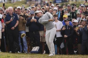 Rory McIlroy plays out of the rough on the fourth hole during the first round of the British Open.