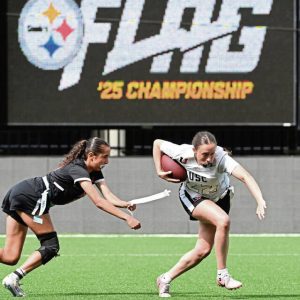 Moon’s Lilian Snyder tackles Upper St. Clair’s Ellie Shanholtzer during the Western Pennsylvania girls flag football championship May 18, 2025 at Highmark Stadium.