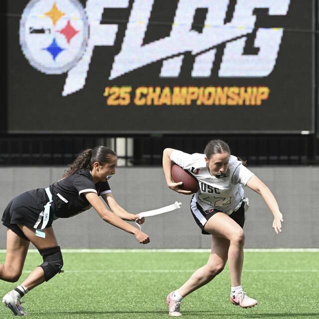 Moon’s Lilian Snyder tackles Upper St. Clair’s Ellie Shanholtzer during the Western Pennsylvania girls flag football championship May 18, 2025 at Highmark Stadium.
