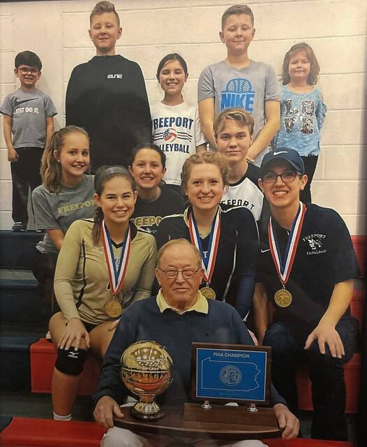 Harry Crytzer holds Freeport girls volleyball’s 2017 PIAA Class 2A championship trophy as he is surrounded by several of his great grandchildren, including then team members, from left, Cora, Claire and Grant Crytzer.