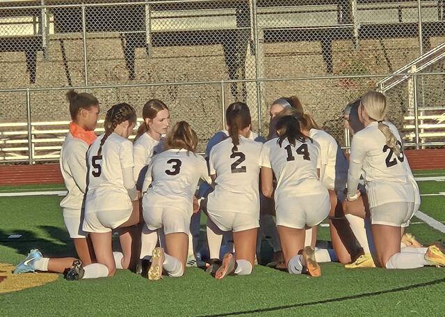 Greensburg Central Catholic girls soccer players huddle before a WPIAL Class A preliminary-round playoff game at California last season.