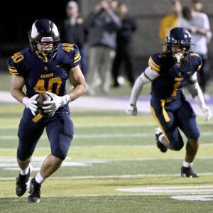Central Catholic’s Colsen Gatten intercepts a pass and returns it for a touchdown against North Allegheny on Friday, Sept. 27, 2024, at Baldwin High School.