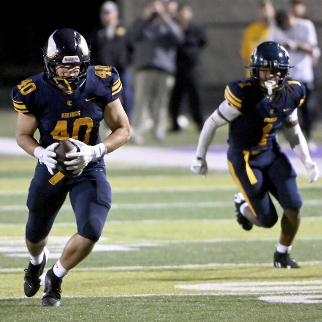 Central Catholic’s Colsen Gatten intercepts a pass and returns it for a touchdown against North Allegheny on Friday, Sept. 27, 2024, at Baldwin High School.