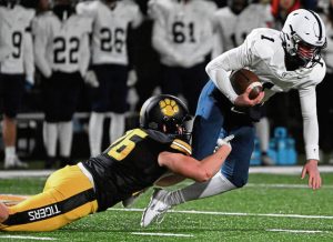 North Allegheny’s Lincoln Hoke takes down McDowell quarterback Blayze Myers during a PIAA Class 6A quarterfinal game Nov. 24, 2023 at North Allegheny High School.