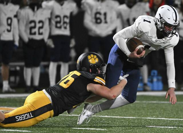 North Allegheny’s Lincoln Hoke takes down McDowell quarterback Blayze Myers during a PIAA Class 6A quarterfinal game Nov. 24, 2023 at North Allegheny High School.