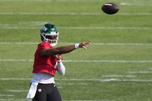 Jets quarterback Justin Fields throws a pass as he takes part in drills at training camp Thursday.