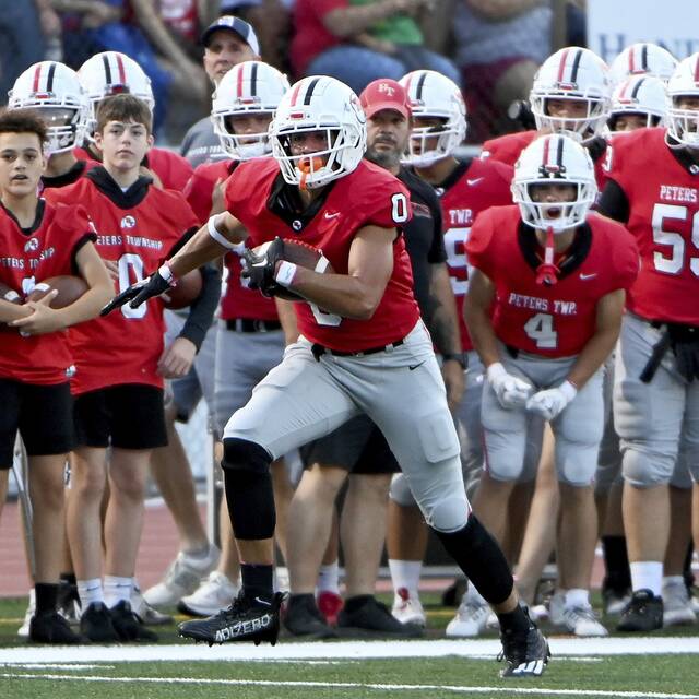 Peters Township’s Lucas Shanafelt picks up yardage against McKeesport on Aug. 30, 2024, at Peters.