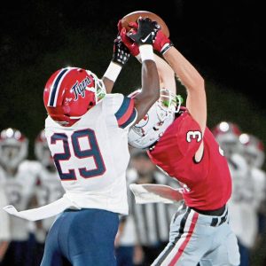 McKeesport’s Javien Robinson (left) battles for possession of a pass with Peters Township’s PJ Luke on Friday, Aug. 30, 2024, at Peters.