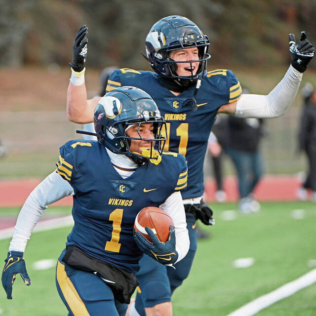 Central Catholic’s Chrys Black (1) celebrates with Bradley Gompers after intercepting a pass in the end zone to seal the victory against Harrisburg during a PIAA Class 6A semifinal Nov. 30, 2024, at Mansion Park in Altoona.