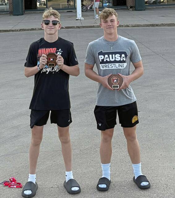 North Allegheny wrestlers Joey Synan (left) and Evan Schomburg display their coveted “stop sign” plaques after earning All-America honors.