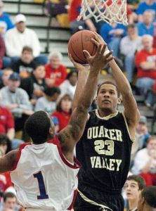 Dorian Goosby-Dean of Quaker Valley goes up for two against Jordan Hall (1) of Jeannette during a game Feb. 21, 2009, at Plum.
