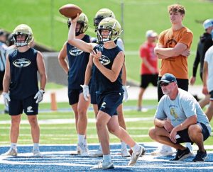 Franklin Regional head coach Lance Getsy looks on as quarterback Nick Devola throws during the WCCA 7-on-7 tournament July 17, 2025, at Hempfield Area High School.