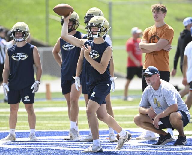 Franklin Regional head coach Lance Getsey looks on as quarterback Nick Devola throws during the WCCA 7-on-7 tournament July 17, 2025, at Hempfield Area High School.