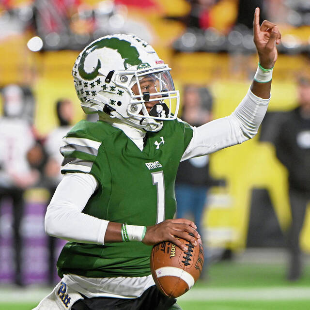 Pine-Richland quarterback Aaron Strader scrambles to pass against Peters Township during the WPIAL Class 5A championship game Nov. 23, 2024, at Acrisure Stadium.